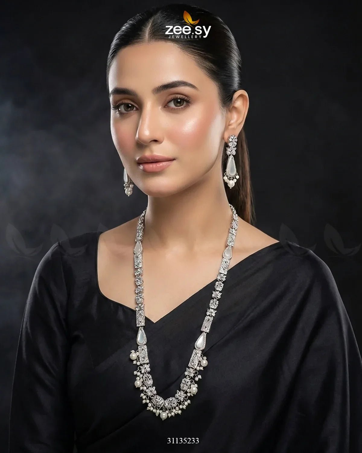 Woman wearing a black saree with a prominent necklace and earrings on a dark background, featuring the Zee Sy brand.