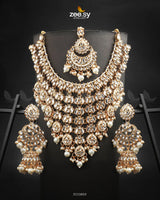 Uzma Bridal Set is intricately designed necklace set features cascading layers of dazzling stonework, creating a regal and luxurious appeal. Making it perfect for grand occasions. With fine craftsmanship and exquisite detailing.