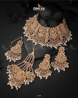 Yarrow Bridal Set is crafted with a&nbsp;black copper rhodium polish, enhancing its regal and antique appeal. The intricate design is adorned with stones, meticulously arranged to create a stunning visual effect. The set is complemented by cascading embellishments, adding depth and elegance. The set is further accentuated with droplet-shaped beads, adding a touch of sophistication.