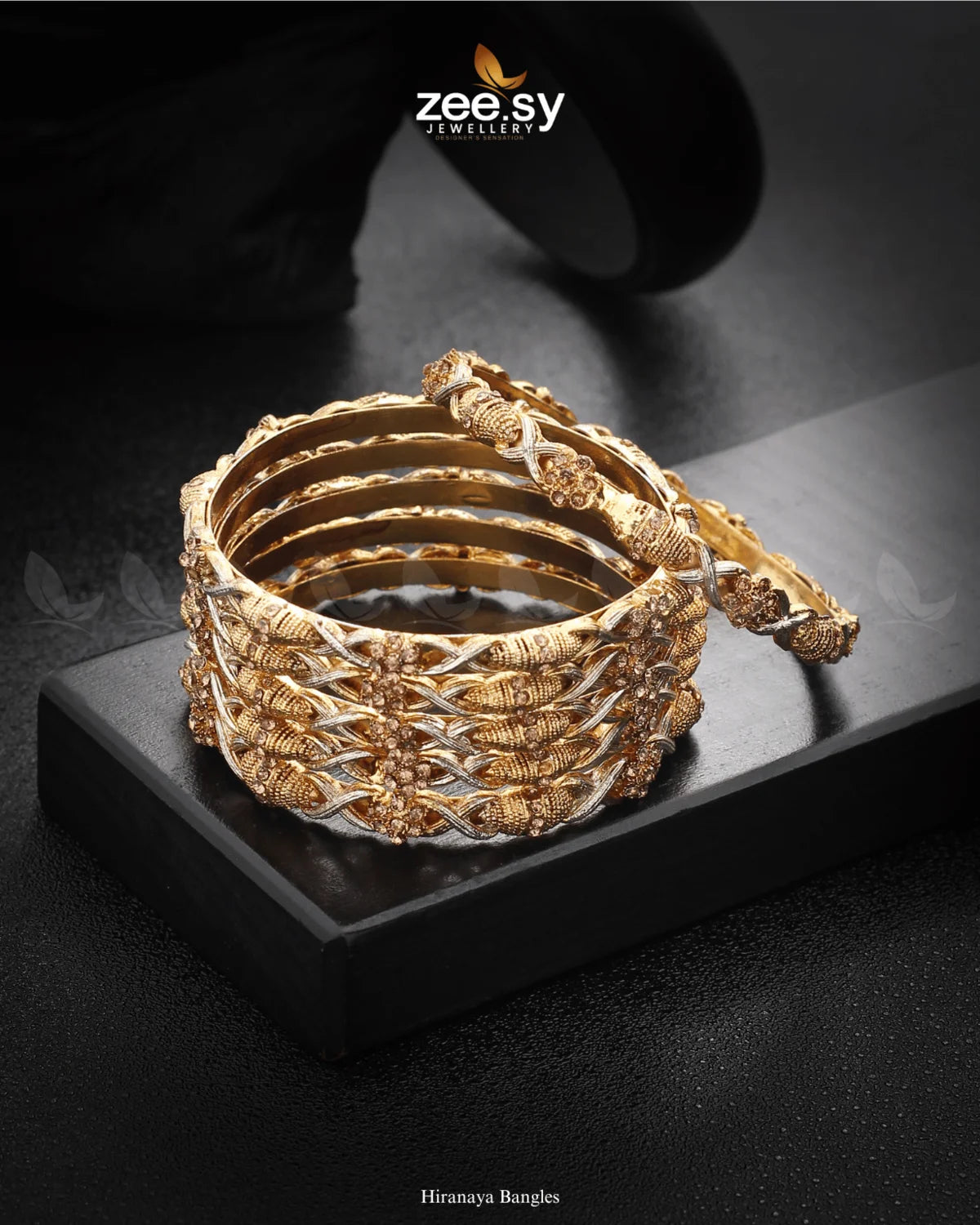 Zariya Bangles showcase an exquisite blend of intricate patterns and shimmering stone embellishments, enhanced with rhodium-polished accents. The twisted rope-like design, paired with floral motifs, creates a captivating and elegant look. Perfect for weddings, festive occasions, and special gatherings, these bangles add a touch of sophistication to any ethnic ensemble.