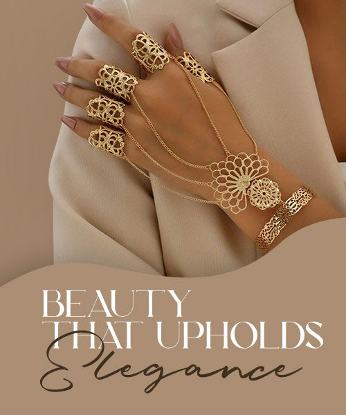 Woman wearing gold hand jewelry with rings and chain