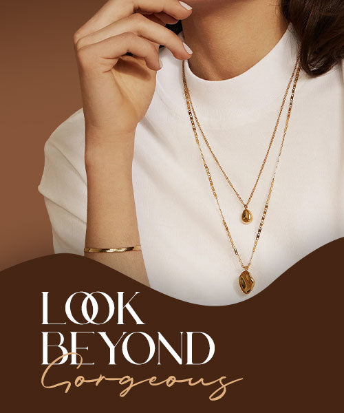 Layered gold necklaces and bracelet worn by woman, modern luxury women’s jewelry on neutral background