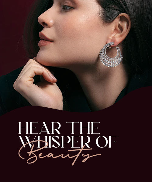 Model wearing elegant gold earrings against a dark background