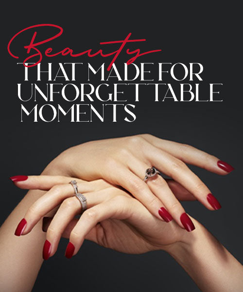 Woman’s hands wearing gold rings with red nail polish