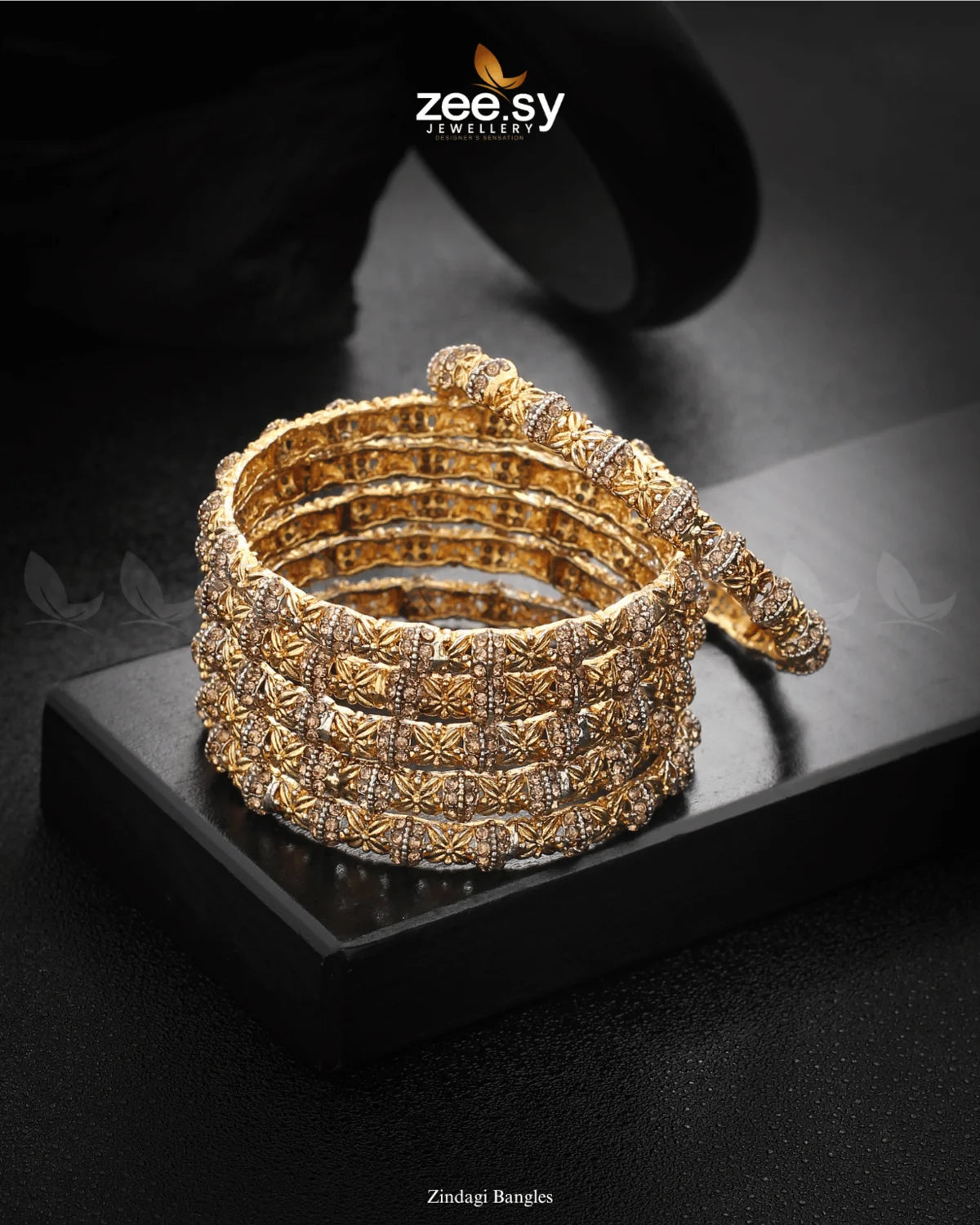 Zindagi Bangles are crafted on a rhodium-polish base, these bangles feature a meticulously detailed pattern, accentuated by shimmering stones that enhance their brilliance. The perfect fusion of tradition and sophistication, these bangles are an ideal choice for weddings, festive occasions, and cultural celebrations.