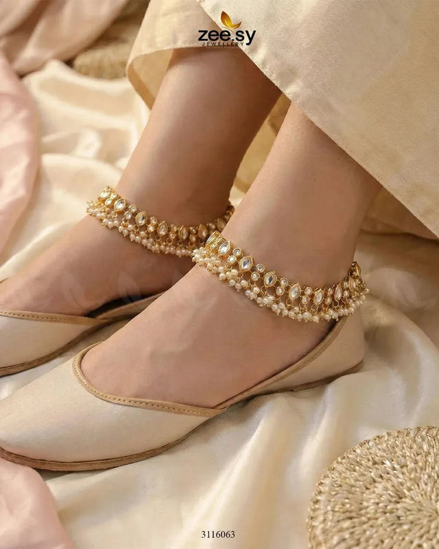 Golden white enstatite anklets with intricate design, crafted by RHS09, featuring sparkling enstatite stones.