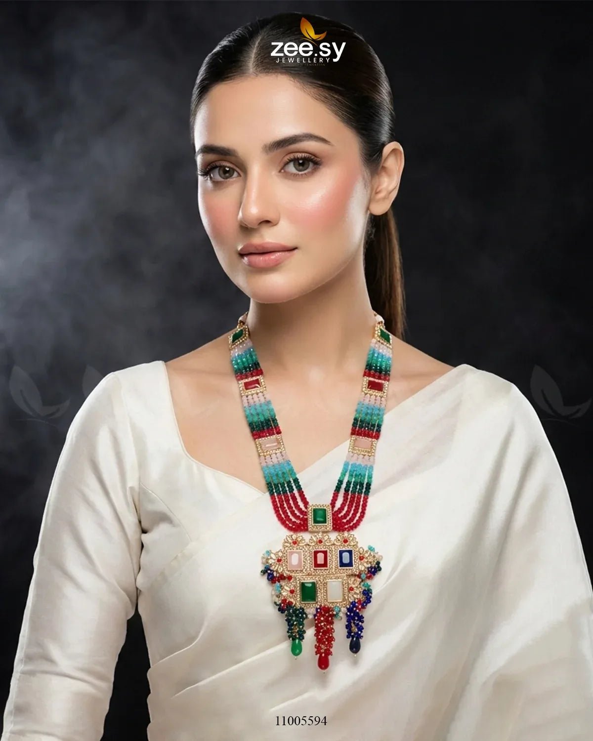 Woman wearing a colorful necklace with a dark background, featuring the Zee Sy brand.